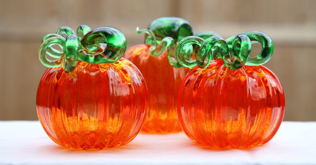 three orange pumpkins